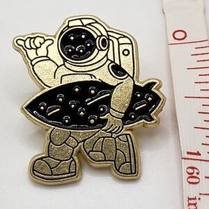 Gold and Black Astronaut with a surfboard Pin